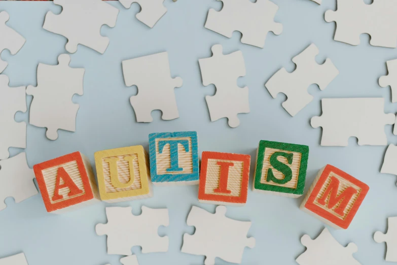 puzzle pieces with the word autism spelled on them, by Ruth Simpson, trending on pexels, visual art, squares, confetti, studio shot, elliot alderson