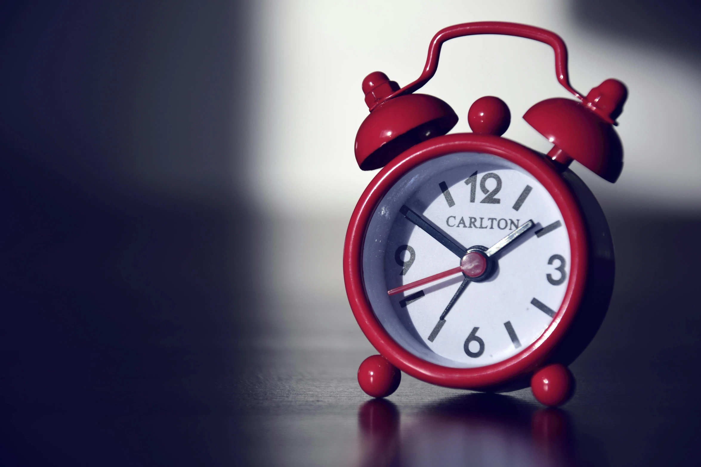 a red alarm clock sitting on top of a table, carson ellis, cgnation, paul barson, schools