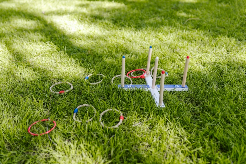 a game of croquet in the grass on a sunny day, rings, square, thumbnail, blue and orange rim lights