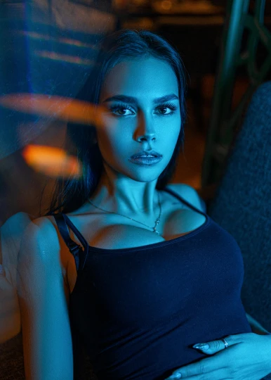 a beautiful young woman sitting on top of a couch, inspired by Elsa Bleda, anton fadeev 8 k, headshot profile picture, blue neon, cinematic. by leng jun