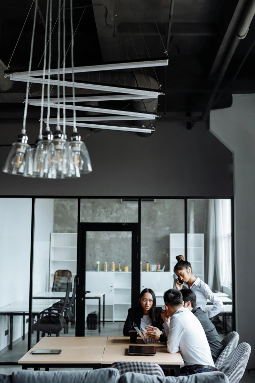 a group of people sitting around a wooden table, pexels contest winner, modernism, industrial lighting, gif, office, tall ceiling