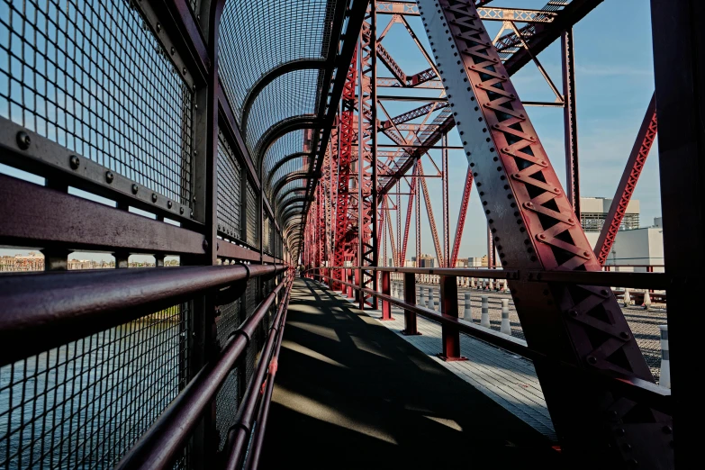 a red metal bridge over a body of water, inspired by William Berra, unsplash contest winner, graffiti, great light and shadows”, medium format color photography, urban city photography, 2000s photo