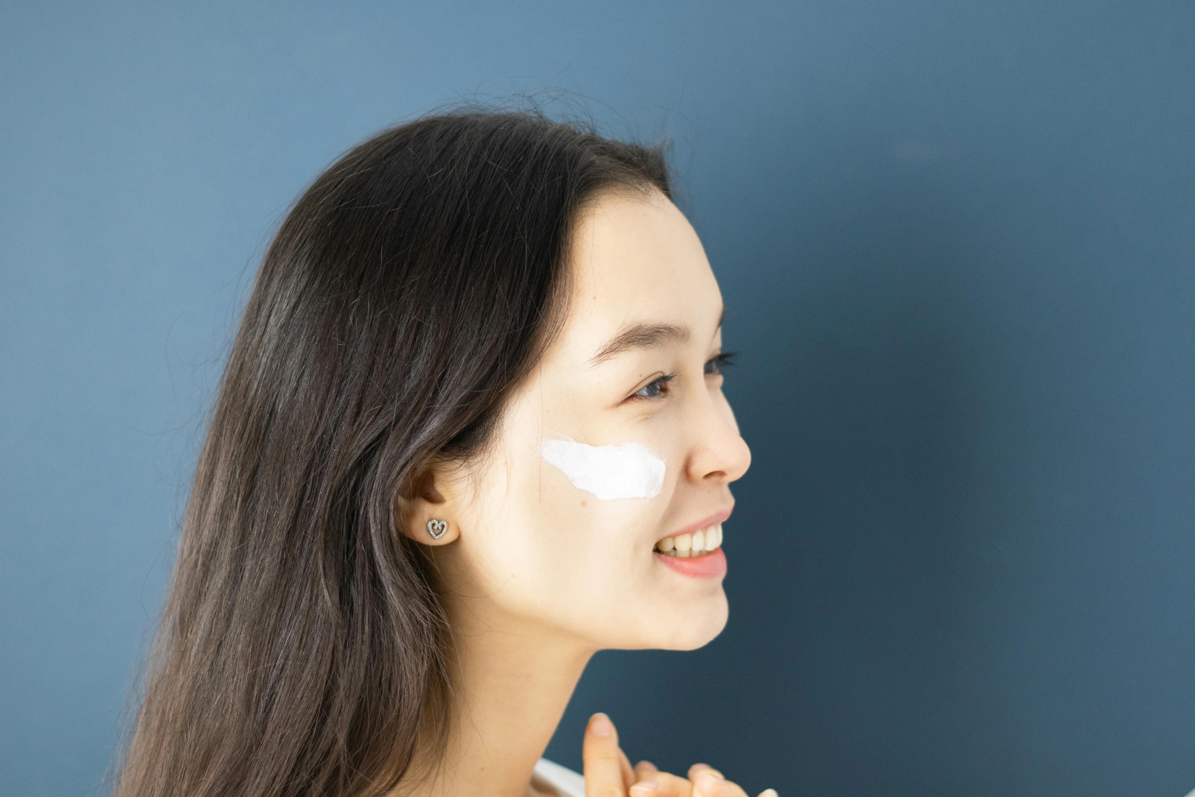 a woman brushing her teeth with a toothbrush, by Nicolette Macnamara, trending on pexels, happening, asian beautiful face, white facepaint, background image, billboard image