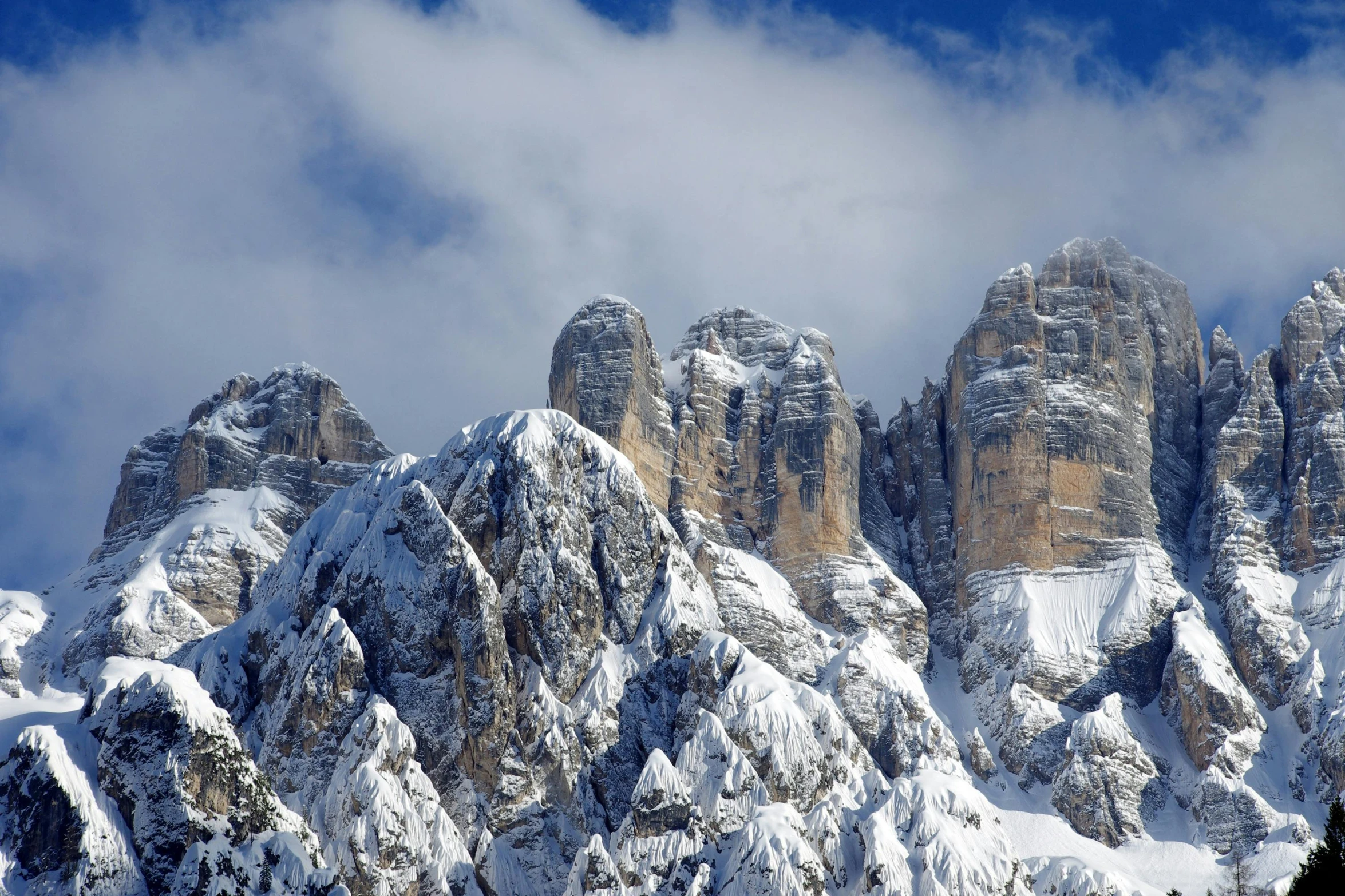 a group of people riding skis on top of a snow covered mountain, tall stone spires, in the dolomites, avatar image