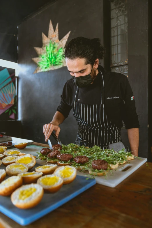 a man that is standing in front of a tray of food, plating, operating on burgers, zigor samaniego style, profile image