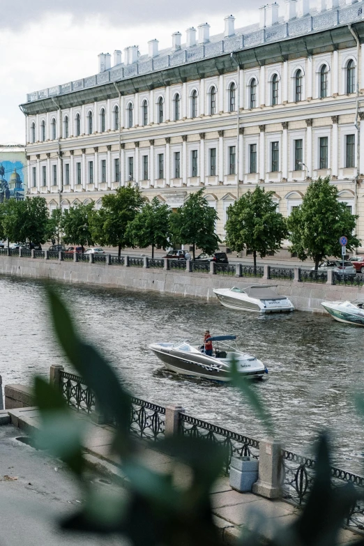 a couple of boats that are in the water, an album cover, inspired by Illarion Pryanishnikov, pexels contest winner, in moscow centre, exterior view, canal, zoomed out view