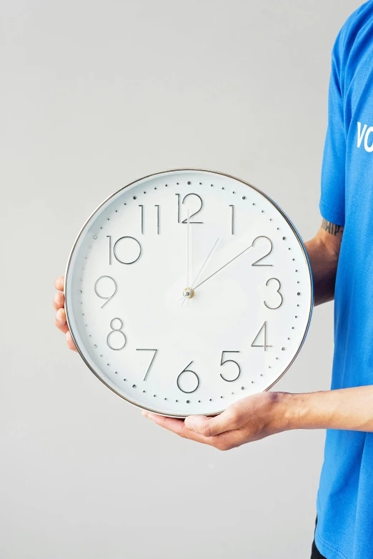 a man in a blue shirt holding a clock, glossy white metal, made out of shiny white metal, thumbnail, product shot