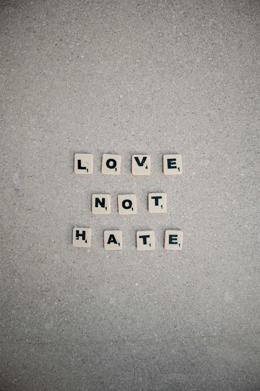 the words love not hate spelled in scrabbles, an album cover, by Nina Hamnett, unsplash, 2 5 6 x 2 5 6 pixels, anarchy, nationalist, julian ope