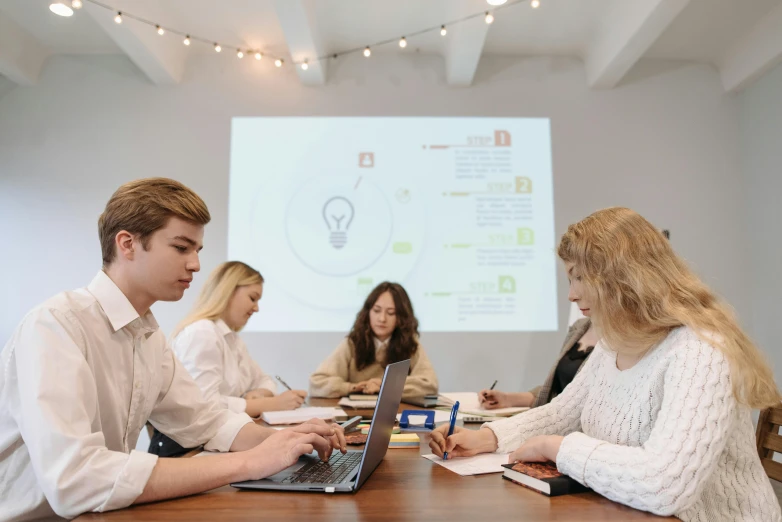 a group of people sitting around a table with laptops, by Adam Marczyński, pexels contest winner, academic art, whiteboard, projections, background image