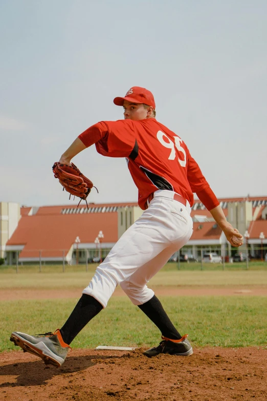 a man pitching a baseball on top of a field, by Robert Storm Petersen, pexels contest winner, red uniform, full body image, square, andreas m wiese