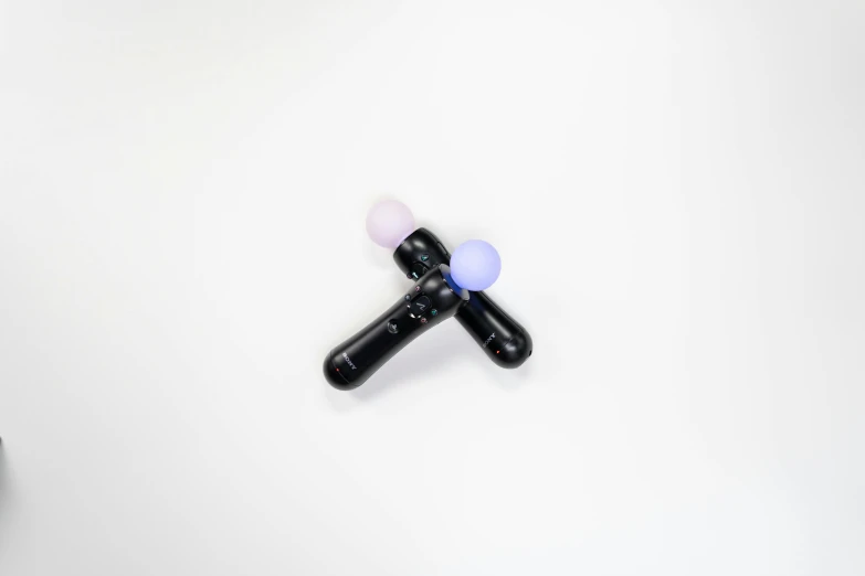 a couple of pills sitting on top of a table, an abstract sculpture, reddit, gradient black to purple, black pearls, vibrating, set against a white background