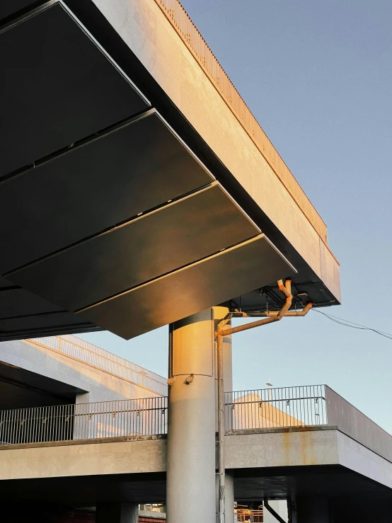 a couple of cars that are parked in front of a building, an album cover, inspired by Ned M. Seidler, unsplash, brutalism, ceiling hides in the dark, close up shot from the side, metallic bridge, solarised