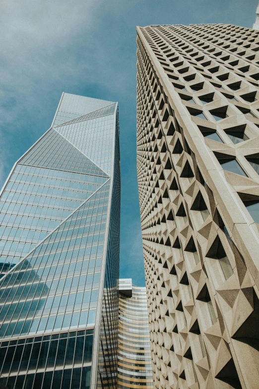 a couple of tall buildings next to each other, pexels contest winner, hypermodernism, sharp angles, buildings carved out of stone, sf, in style of norman foster