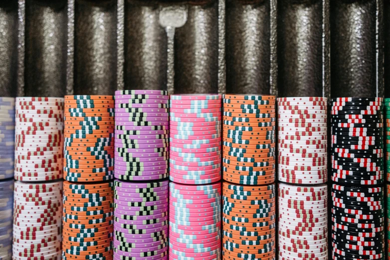 a bunch of poker chips stacked on top of each other, a portrait, unsplash, pop art, mining, patterned, tubes, 🦩🪐🐞👩🏻🦳