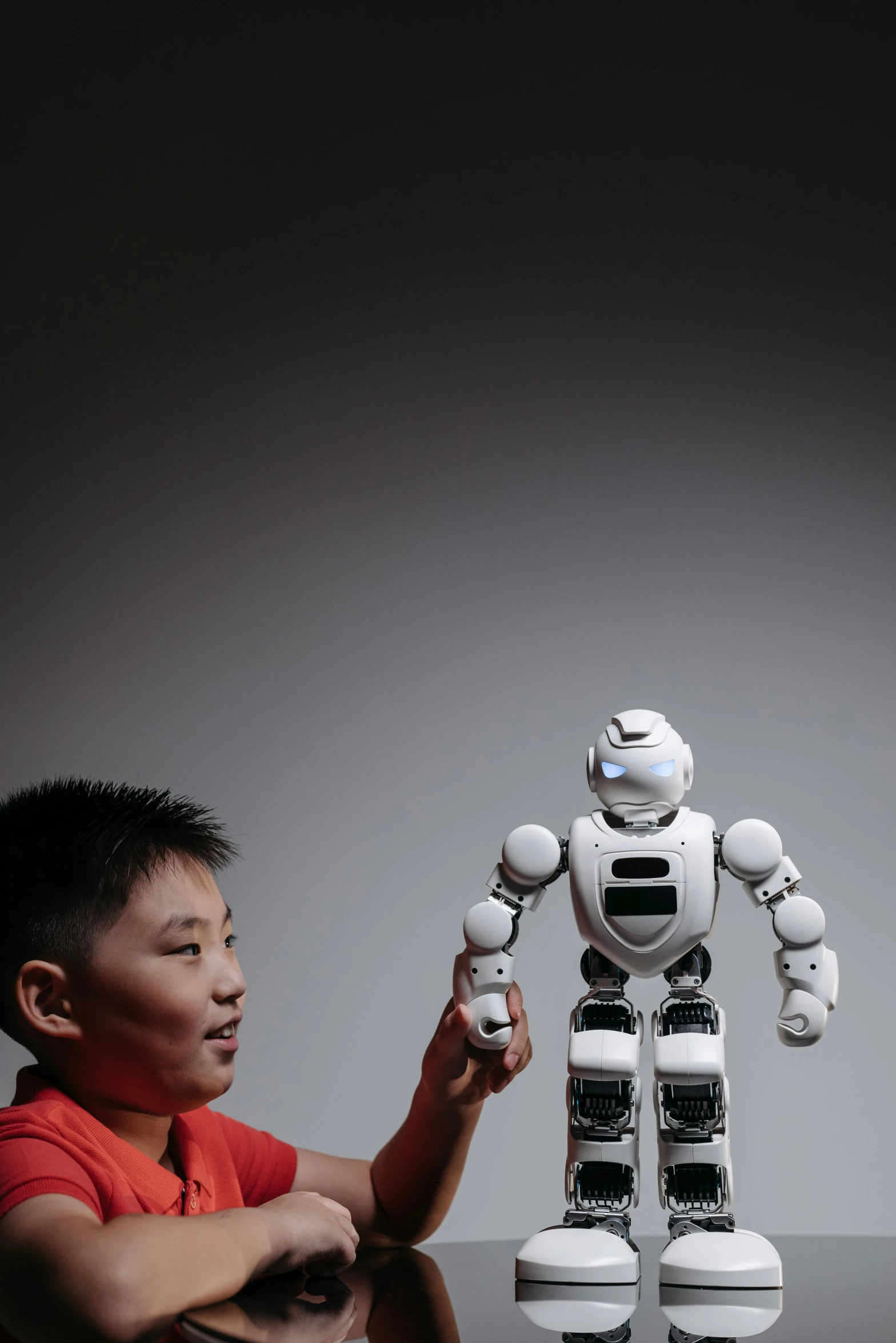 a man holding a remote control in front of a robot, inspired by Feng Zhu, children's, 2019 trending photo, mark lee, explorer