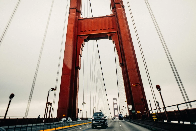 a car driving across the golden gate bridge, pexels contest winner, hyperdetailed photo, tall arches, 🚿🗝📝, modern”