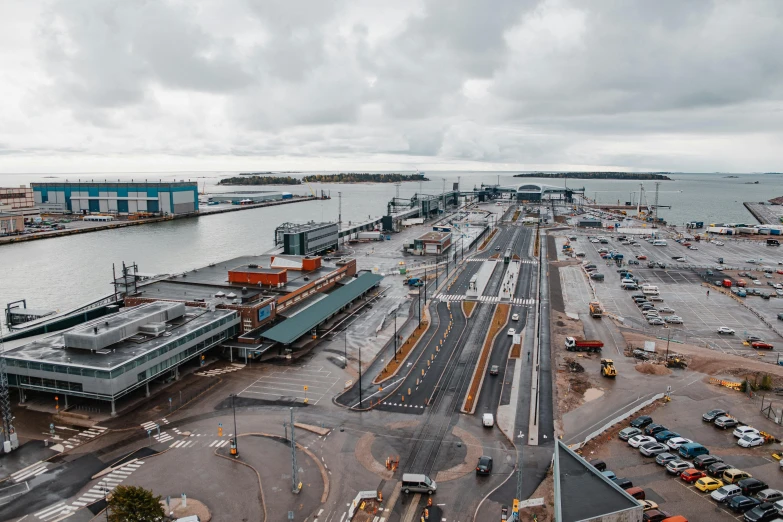 a large parking lot next to a body of water, pexels contest winner, hurufiyya, helsinki, terminals, thumbnail, 1 2 9 7