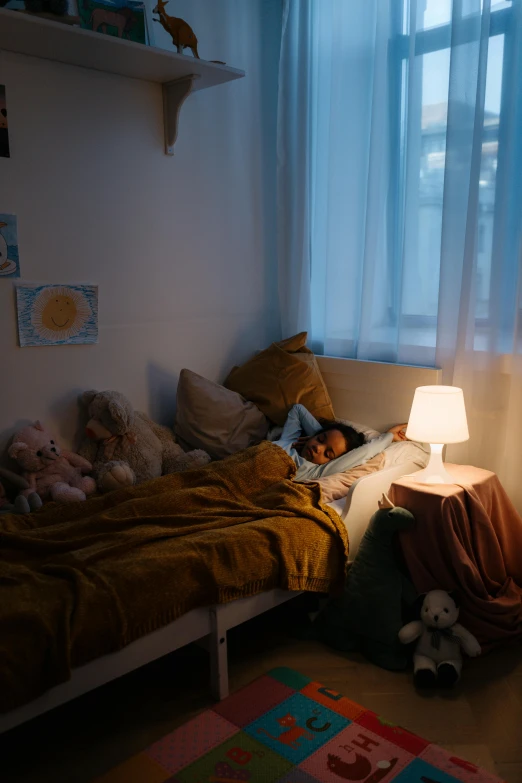 a child laying in a bed next to a window, inspired by Elsa Bleda, pexels contest winner, room lighting, small and cosy student bedroom, light source from the left, middle of the night