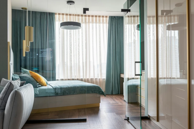 a bed sitting in a bedroom next to a window, by Adam Marczyński, pexels contest winner, with teal clothes, glossy design, glass floor, elegant wardrobe