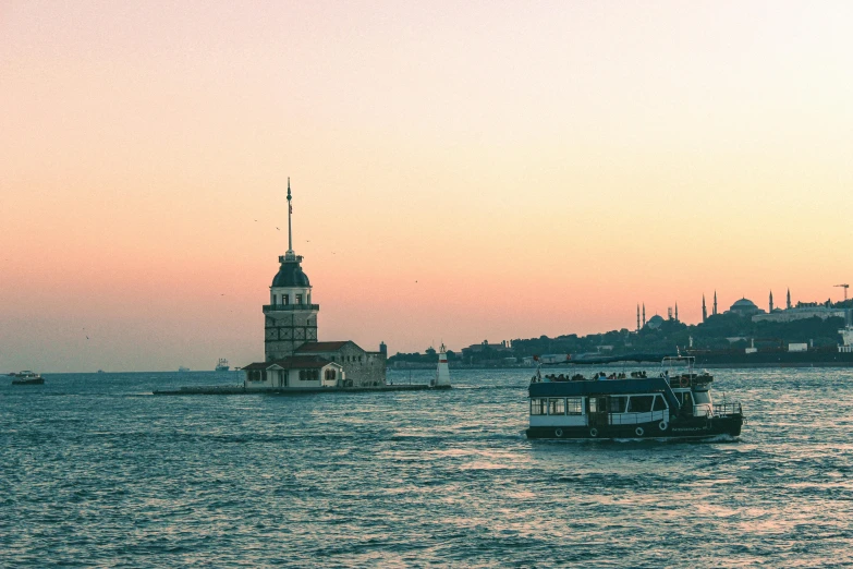 a boat in a body of water with a clock tower in the background, a picture, by Niyazi Selimoglu, hurufiyya, in a sunset haze, fujicolor photo