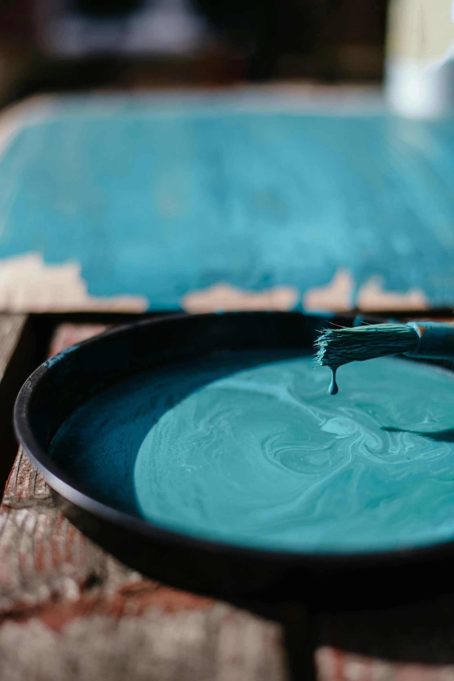 a blue plate sitting on top of a wooden table, a silk screen, inspired by Hu Zao, trending on unsplash, process art, teal hair, pouring techniques, superfine ink detail, chalked