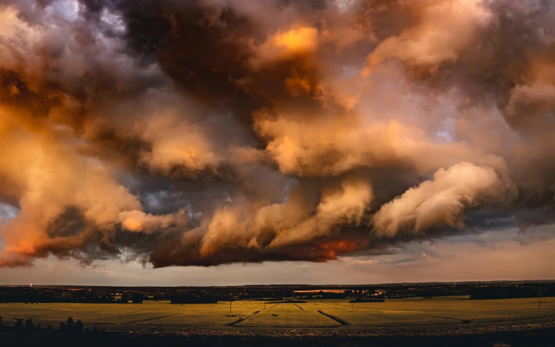 a bunch of clouds that are over a field, by Jesper Knudsen, pexels contest winner, dramatic reddish light, hyperdetailed storm clouds, dramatic earth colors, ultrawide landscape