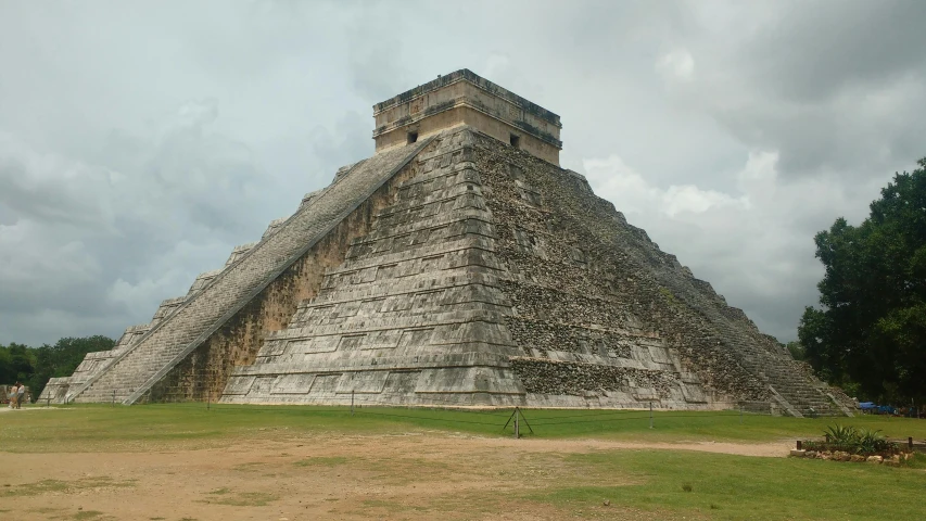 a large pyramid sitting on top of a lush green field, profile image, aztec architecture, multiple stories, massive structures