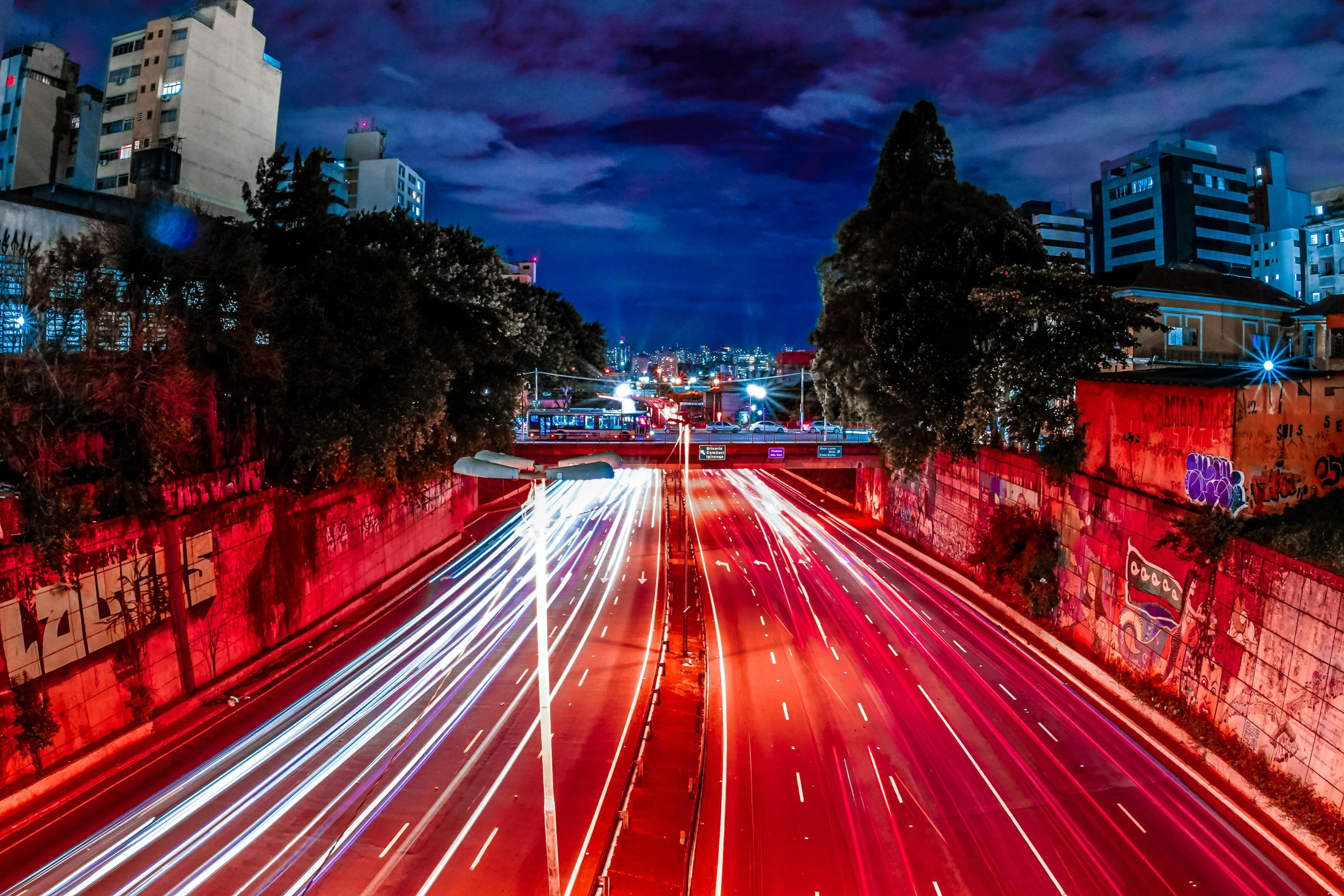 a city street filled with lots of traffic at night, by Matt Stewart, unsplash contest winner, visual art, red lasers, manly, freeway, red and blue back light