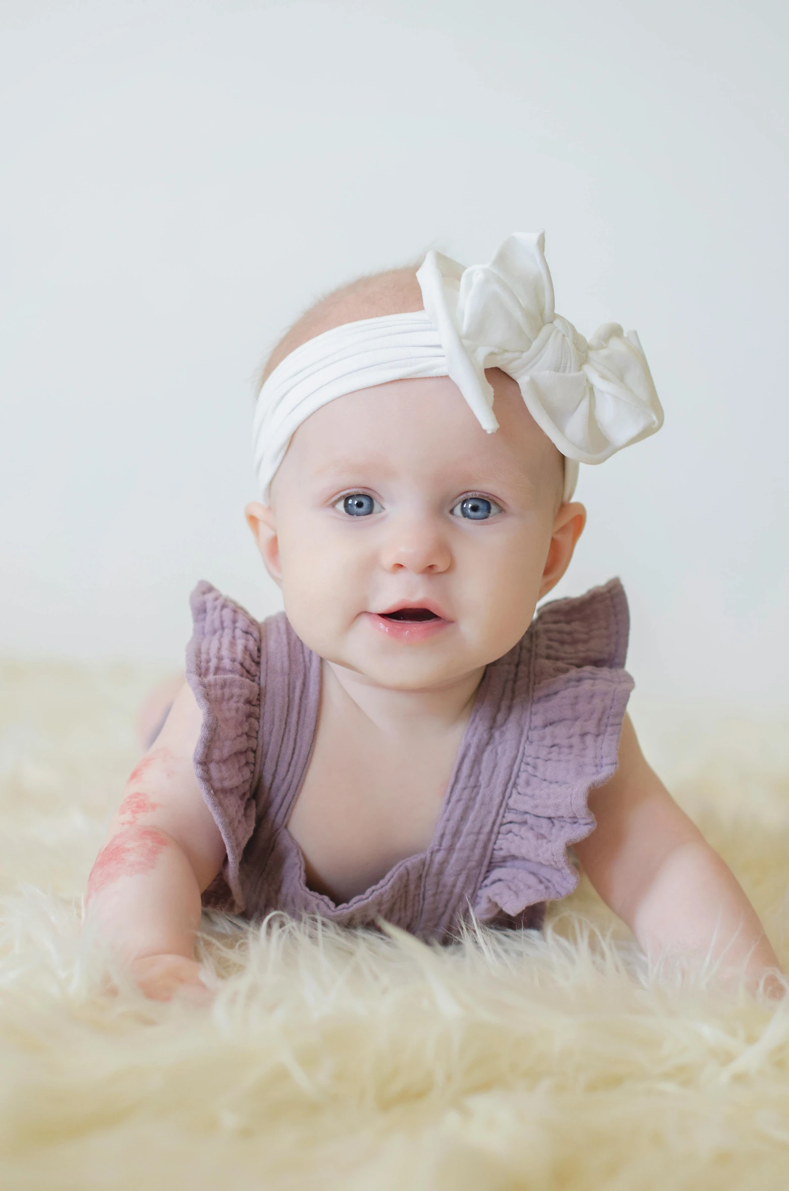 a baby girl wearing a purple dress and a white headband, albino skin, face enhanced, hair bow, professionally color graded