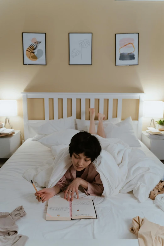 a person laying on a bed reading a book, kid drawing, serene bedroom setting, taken with sony alpha 9, full-body