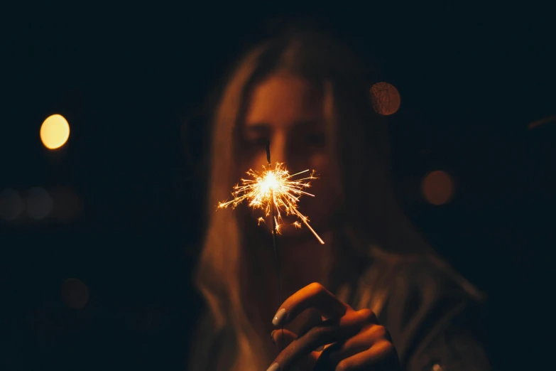 a woman holding a sparkler in her hand, pexels contest winner, instagram post, dark warm light, profile image, fourth of july