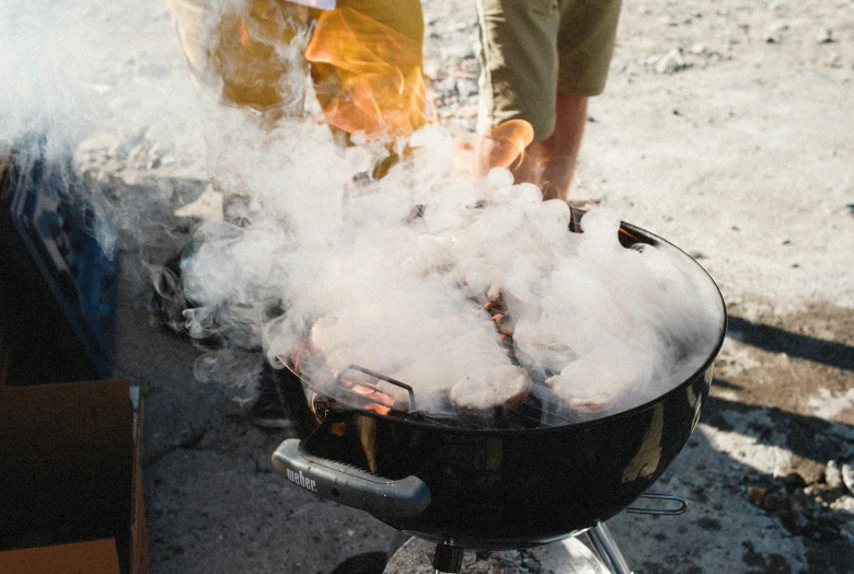 a person standing over a grill with smoke coming out of it, pexels contest winner, steamboat willy, manuka, camp, gushy gills and blush