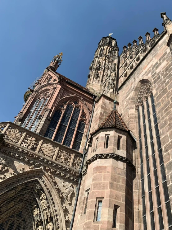 a tall building with a clock on the front of it, inspired by Rainer Maria Latzke, pexels contest winner, nuremberg, inside cathedral, sunny sky, intricate copper details