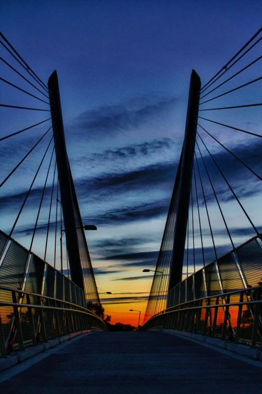 a bridge with a sunset in the background, architecture and more, cables, symmetry, brilliantly coloured