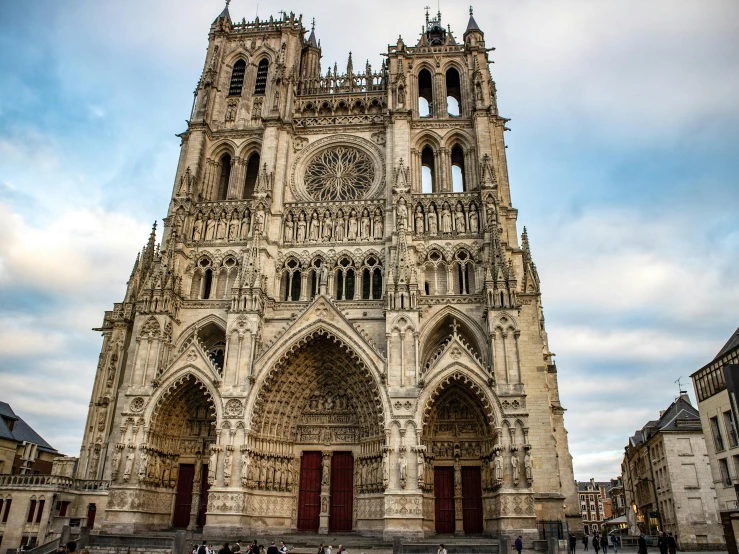 a very tall cathedral sitting in the middle of a city, by Villard de Honnecourt, pexels contest winner, art nouveau, intricate gothic bones and meat, grain”, square, gothic rich deep colors