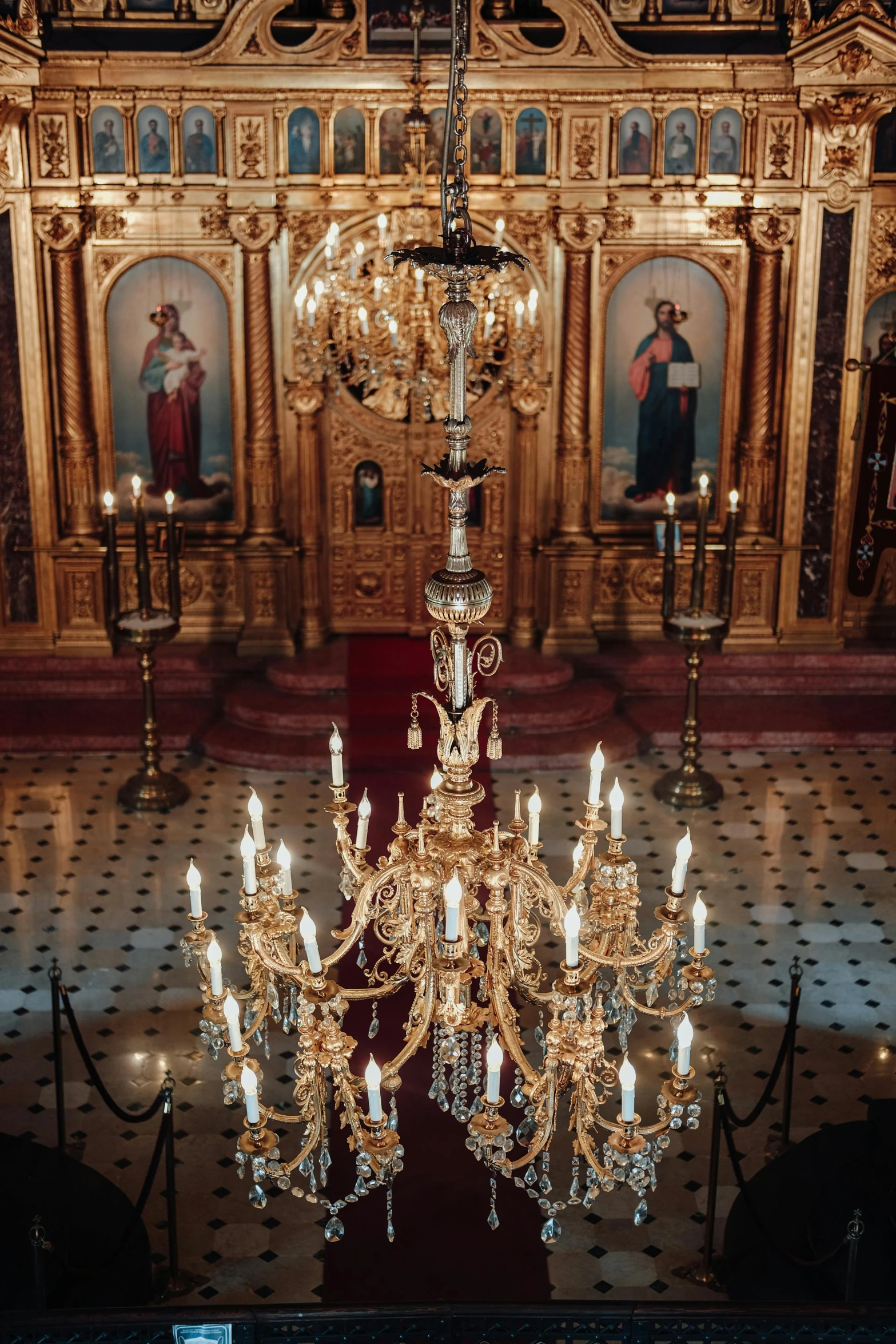 a chandelier hanging from the ceiling of a church, by Serhii Vasylkivsky, trending on unsplash, square, standing in front of the altar, ( ( theatrical ) ), restored