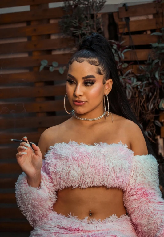 a woman in a fuzzy pink outfit smoking a cigarette, an album cover, inspired by Gina Pellón, trending on pexels, black hair in braids, arab ameera al-taweel, cl, mexican