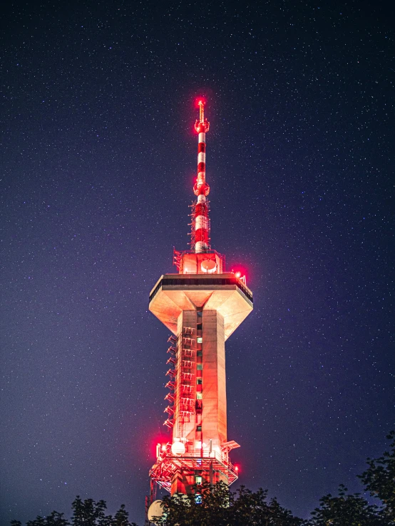 a very tall tower lit up at night, by Julia Pishtar, top of the mountain, red and white lighting, starlight, observation deck