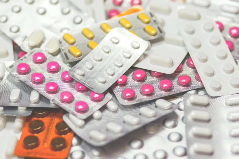 a pile of pills sitting on top of a table, by Daniel Lieske, pexels, plasticien, panels, polka dot, shields, looking partly to the left