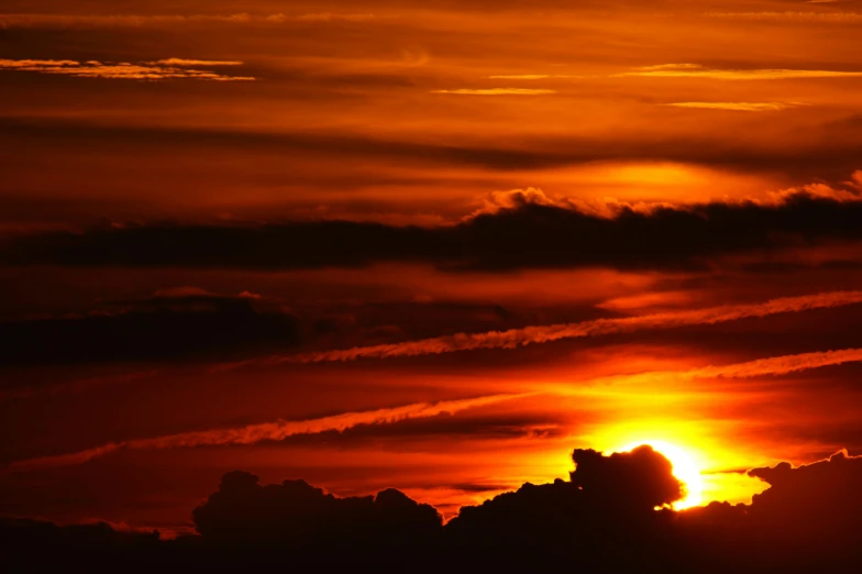 the sun is setting behind the clouds in the sky, pexels, dark oranges reds and yellows, silhouette :7, long, thumbnail