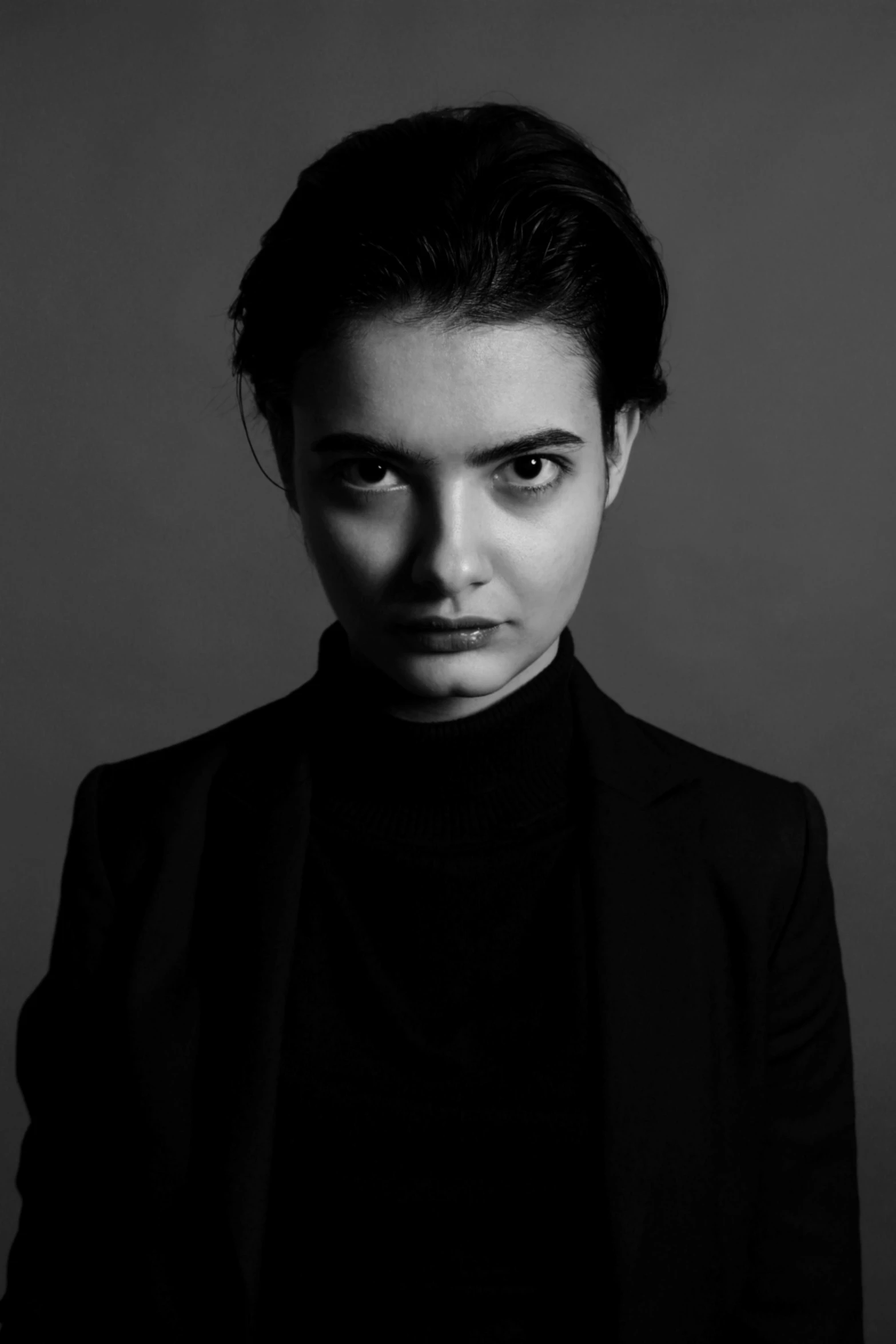 a black and white photo of a woman, a character portrait, by irakli nadar, maisie williams, a man wearing a black jacket, menacing pose, longer eyebrows