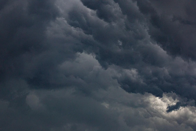 a plane that is flying in the sky, by Steven Belledin, pexels, baroque, dark mammatus cloud, rectangle, grey, mixed art