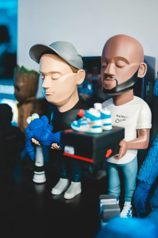 a couple of figurines sitting next to each other, a cartoon, featured on reddit, trending on r/streetwear, standing on a shelf, ultrastation hq, bald head