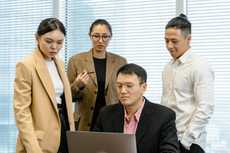 a group of people standing around a laptop computer, by Jang Seung-eop, pexels contest winner, jin shan and ross tran, sat in an office, lachlan bailey, guide