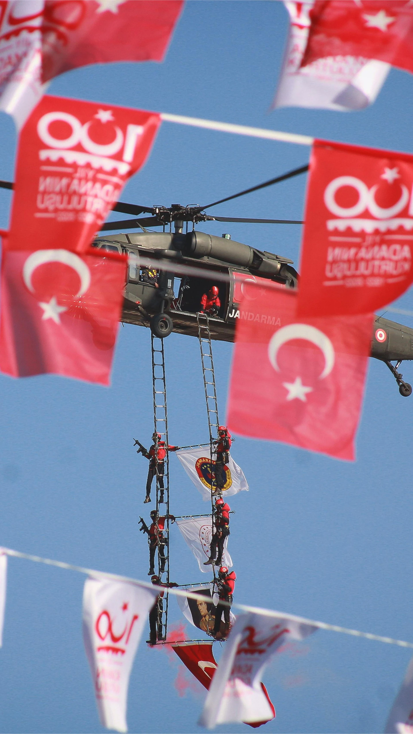 a helicopter that is flying in the sky, by Fikret Muallâ Saygı, flickr, ap press photo, red banners, sitting in a crane, help