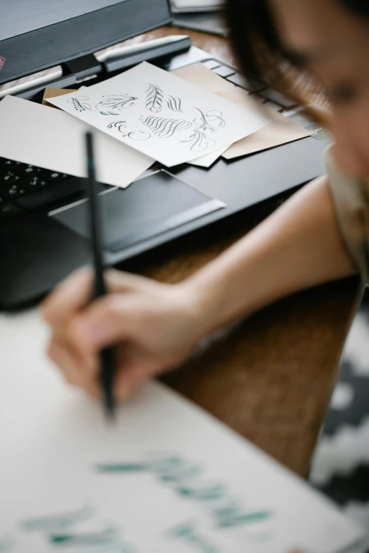 a woman sitting at a desk writing on a piece of paper, a drawing, trending on pexels, arbeitsrat für kunst, creative coder with a computer, matte paiting, 9 9 designs, black on white paper