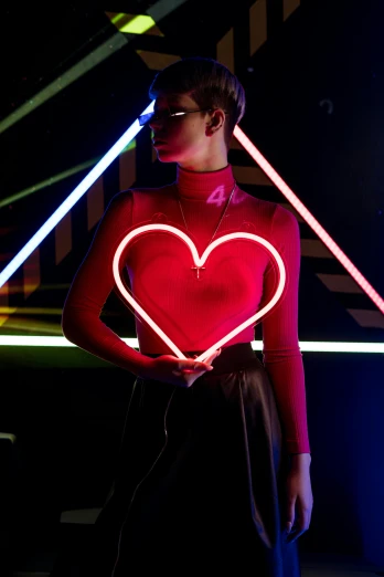 a woman in a red shirt holding a neon heart, trending on pexels, fashion shoot 8k, neon standup bar, ad image, large)}]