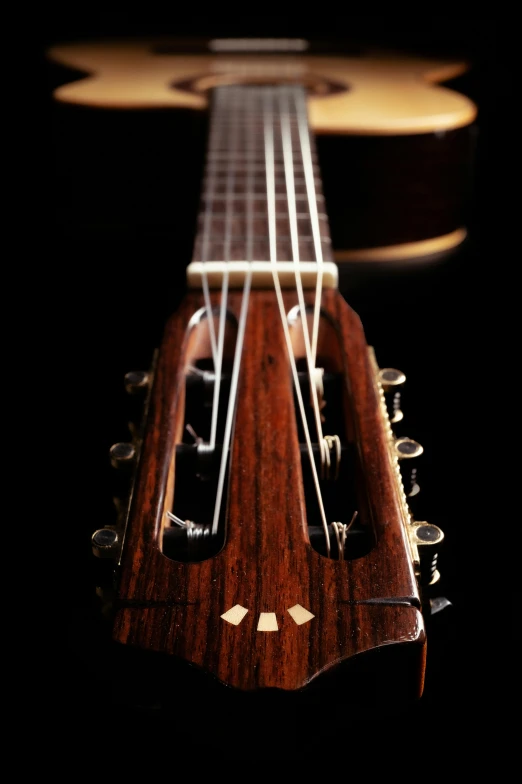 a close up of a guitar on a black background, by Bryan Organ, slide show, straight neck, handcrafted, album