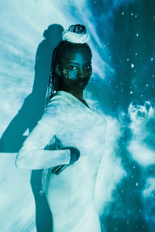 a woman in a white dress posing for a picture, inspired by David LaChapelle, trending on unsplash, afrofuturism, on a galaxy looking background, dark blue skin, white and teal garment, adut akech