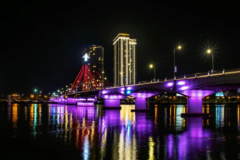 a bridge over a body of water at night, by Julia Pishtar, pexels contest winner, purple lighted street, in style of lam manh, red river, a colorful